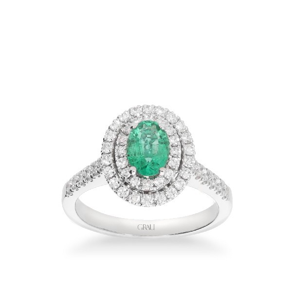 White gold rosette ring with oval Emerald and double halo of Diamonds