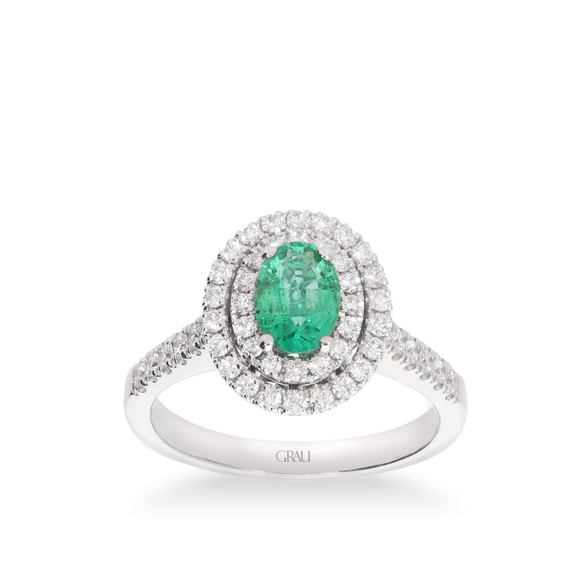 White gold rosette ring with oval Emerald and double halo of Diamonds